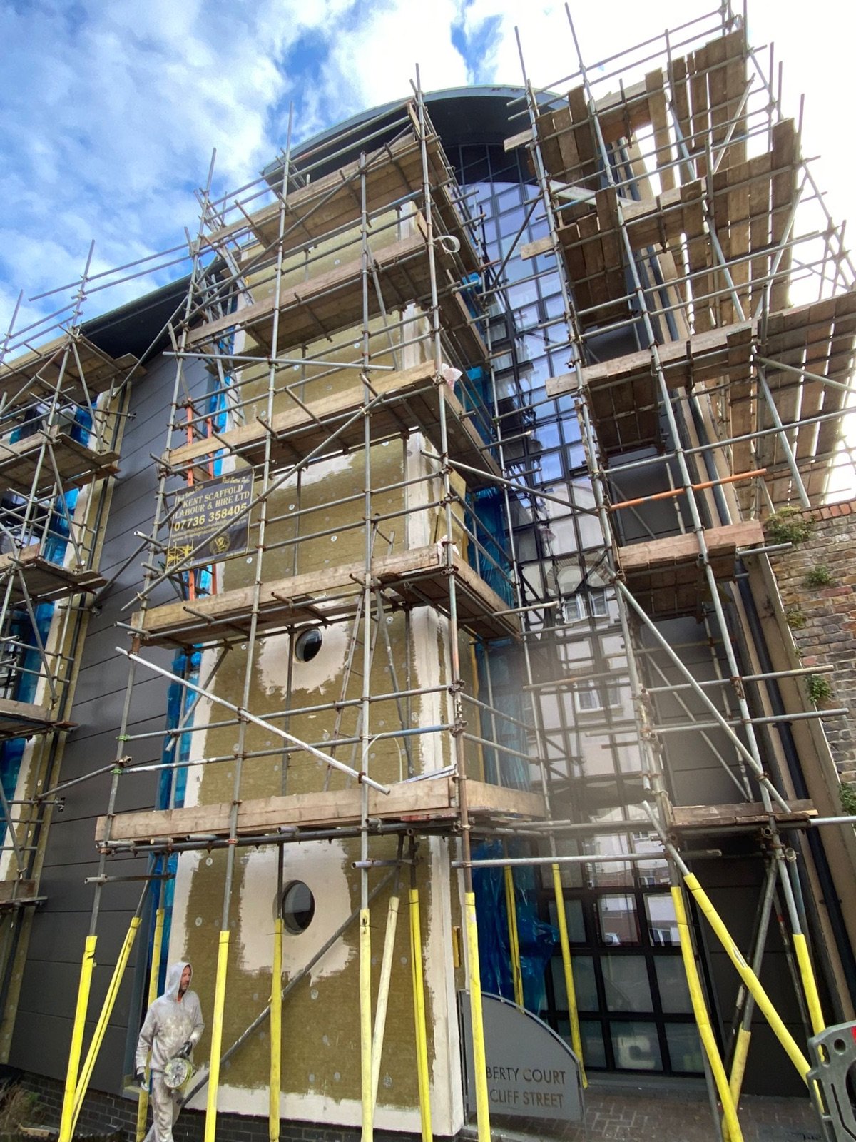 Façade reconstruction progressing across the scaffolded elevation